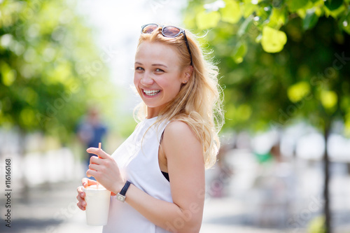 Pretty smiling woman with milkshake