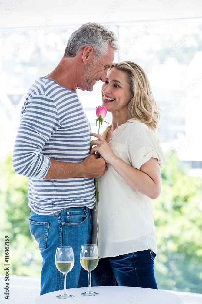 Romantic mature couple with pink rose  - obrazy, fototapety, plakaty 