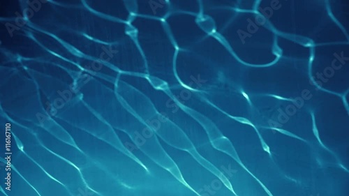 Clear Blue Transparent Water Reflecting The Sun With Slight Waves