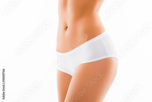 Close up photo of fit slim woman belly and white panties