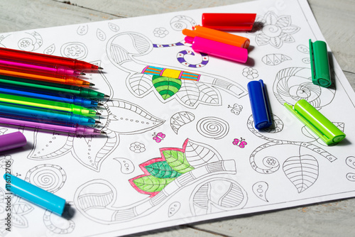 Coloring book for adults with abstract patterns and colored pens, antistress painting