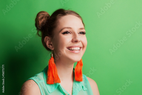 Portrait f a cheerful young girl in bright casual clothes smilin