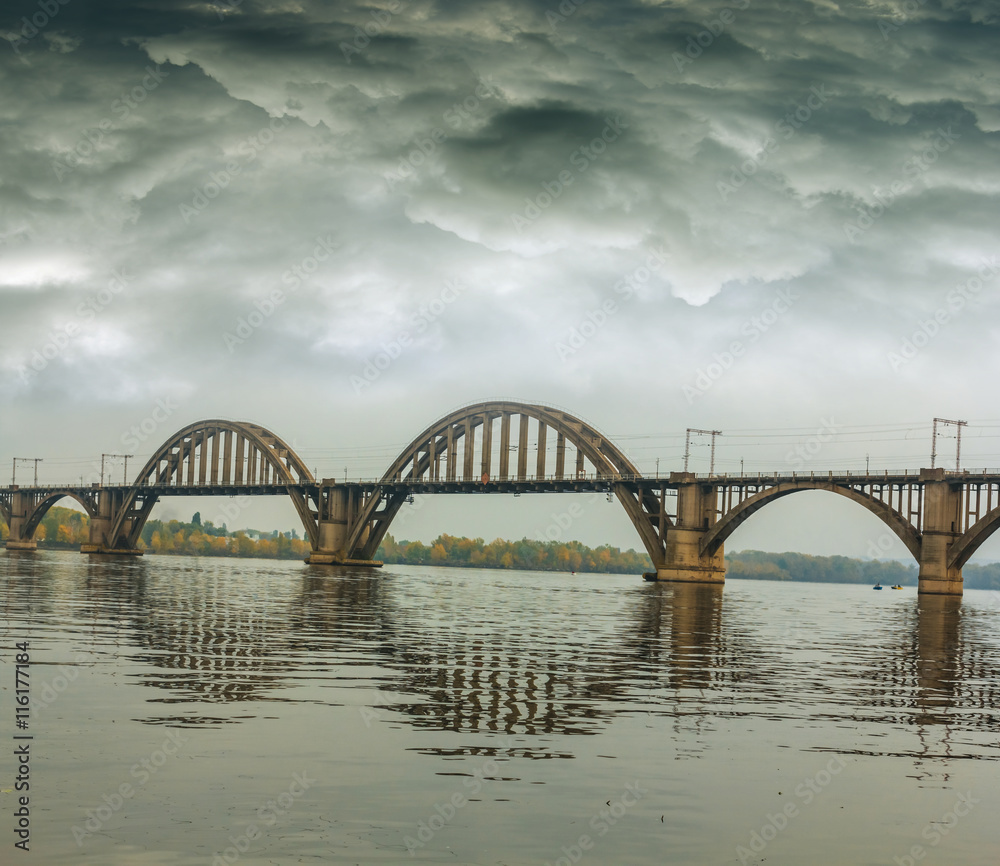 Naklejka premium bridge over a river at the dark wet weather