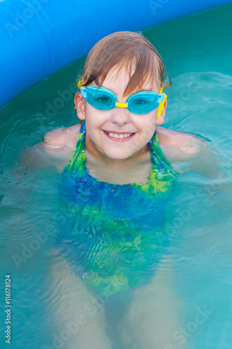 Cheerful Little girl in the pool having fun close-up