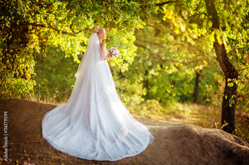 Beautiful bride in white dress in the garden