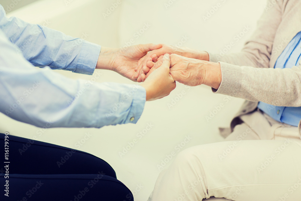 close up of senior and young woman hands close up of senior and young woman hands