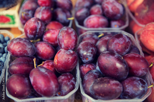 close up of satsuma plums at street market
