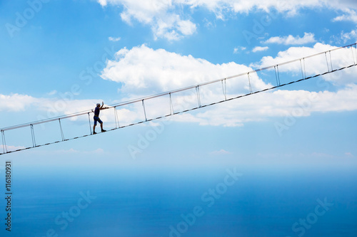Man climbing on the suspension bridge.