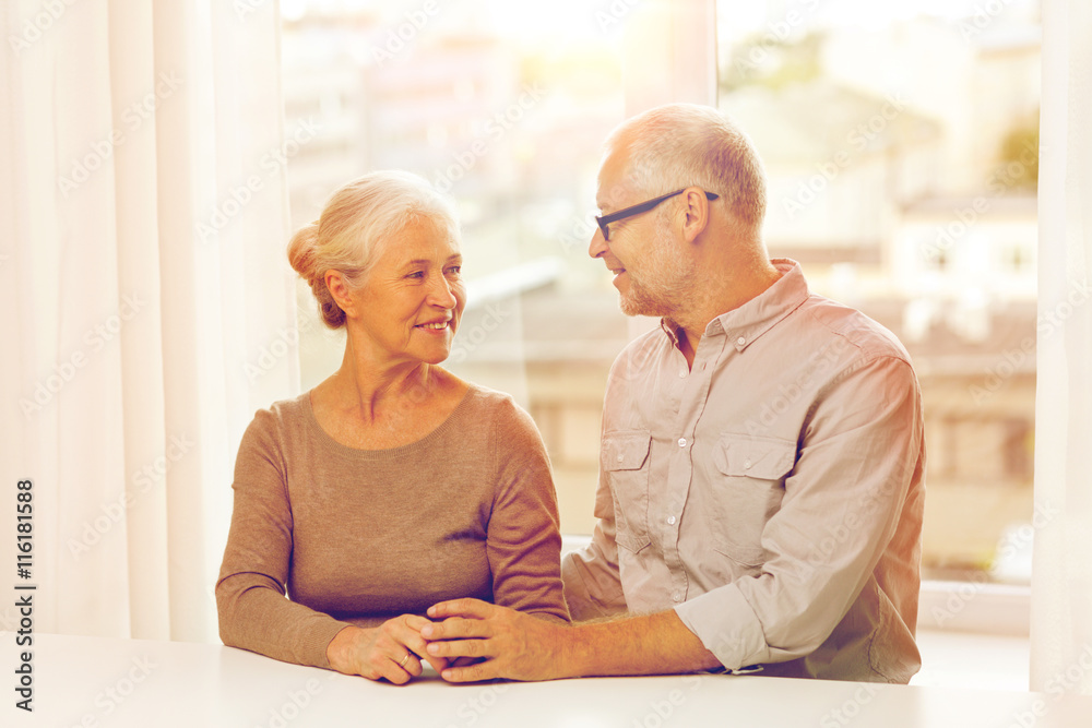 happy senior couple sitting on sofa at home happy senior couple sitting on sofa at home