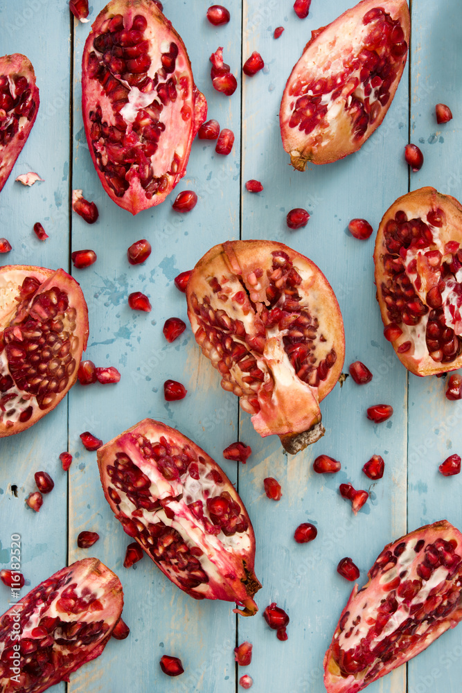 Fototapeta premium Pomegranate on blue wooden background
