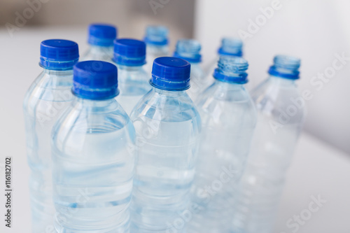 close up of bottles with drinking water on table