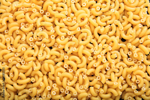 Full background of raw macaroni pasta