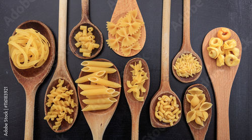 Various shapes of pasta on a black background