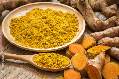 fresh turmeric roots with turmeric powder