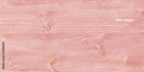 Rose colored wood texture with knotholes