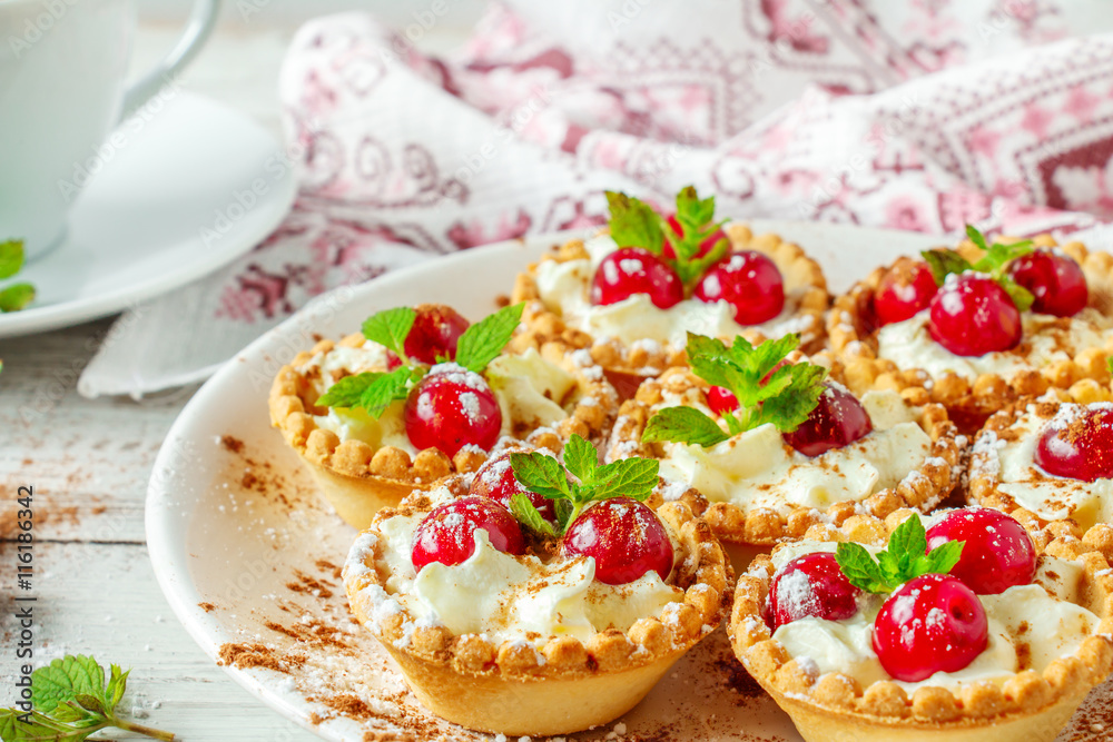 Tartlets with whipped cream and cherry. Tartlets with whipped cream and cherry.