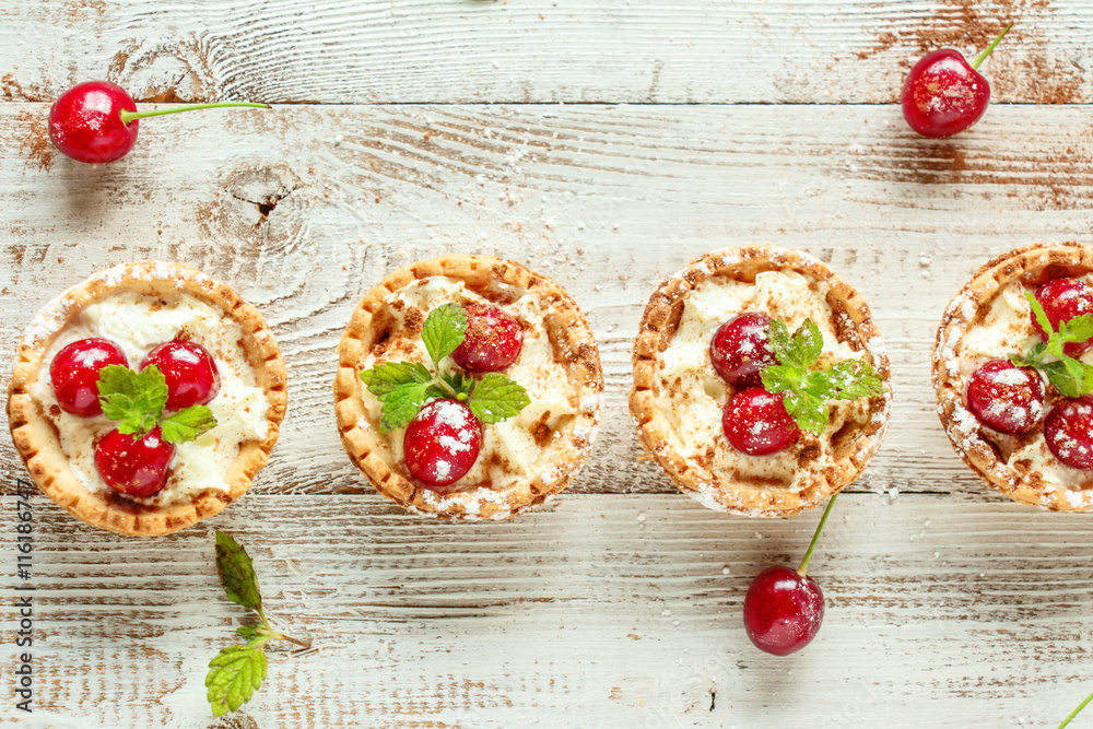Tartlets with whipped cream and cherry. Tartlets with whipped cream and cherry.