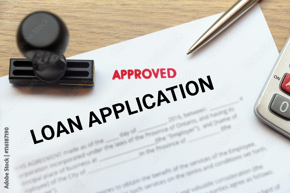 Fototapeta premium Approved loan application form lay down on wooden desk