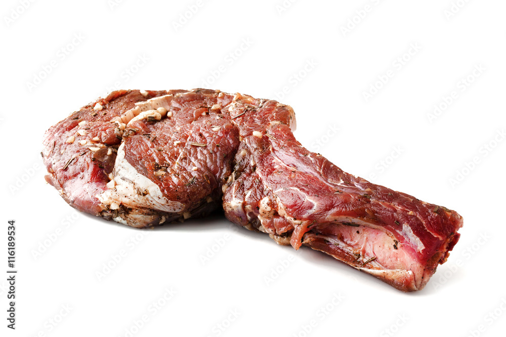Fresh raw beef with spices on a white Fresh raw beef with spices on a white