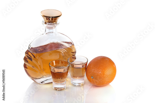 Bottle with glasses tequila and orange on white background