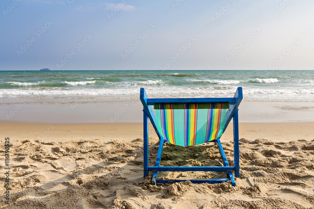 Beach chair on the beach and sea background