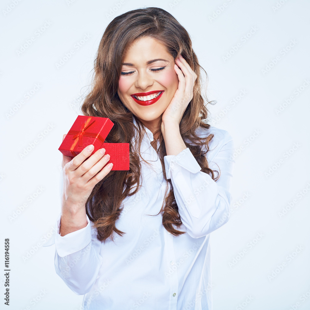 Surprising woman holding little red gift. Curly long hair. Surprising woman holding little red gift. Curly long hair.