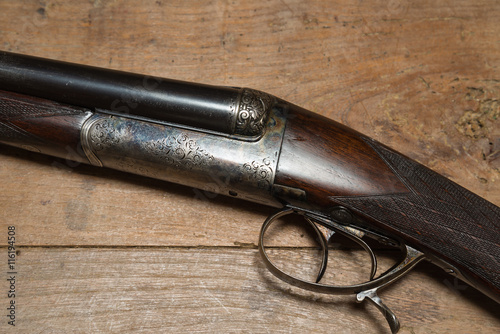 Vintage hunting gun on a wooden background