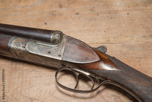 Vintage hunting gun on a wooden background