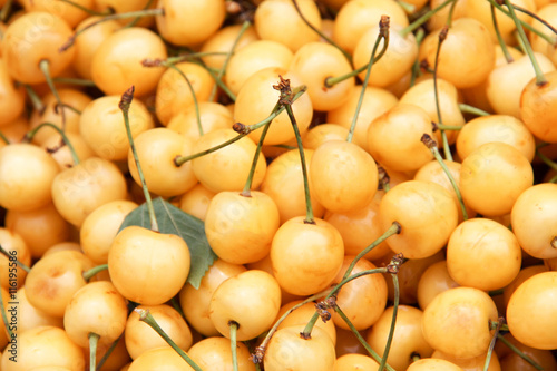yellow cherry as background for sale on the market counter