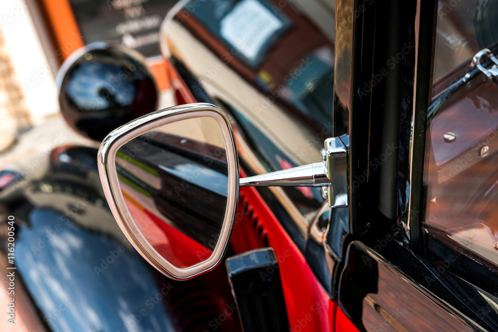 Kiev, Ukraine- July 16, 2016: Vintage car parts and elements. Glossy steel mirror. Selective focus. Little of DOF