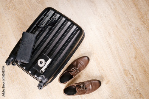  suitcase with clothes lying on the floor before the trip