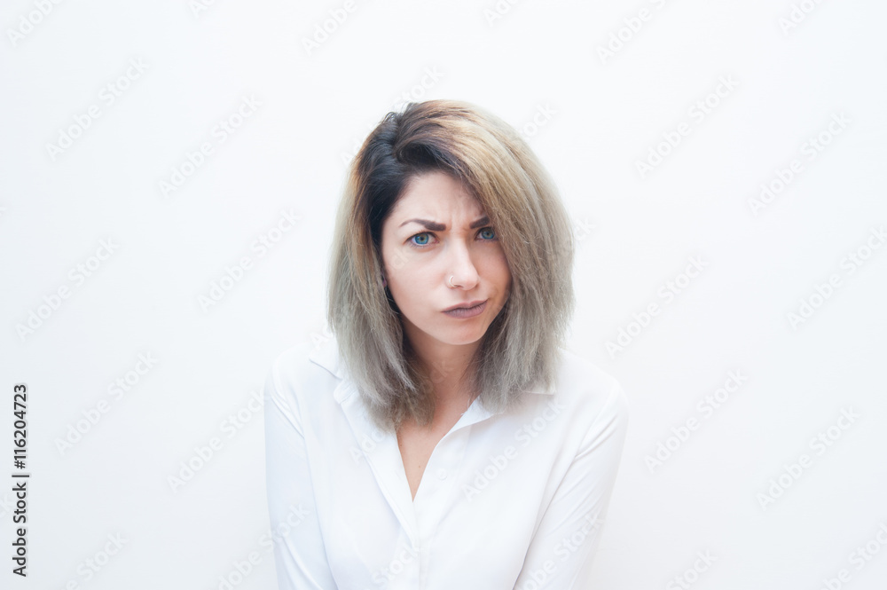 Young blue eyes blonde woman with doubtful face expression Young blue eyes blonde woman with doubtful face expression