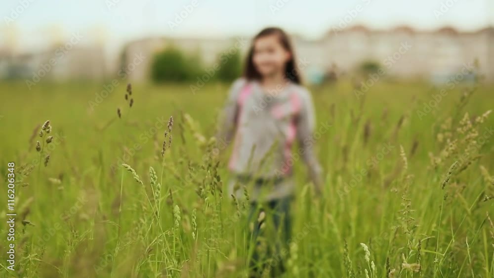 Young girl goes in deep grass Young girl goes in deep grass