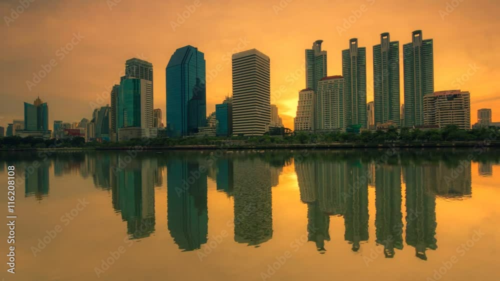 Downtown skyscrapers and the reflection on the water. Orange sky in the evening , Time lapse video Downtown skyscrapers and the reflection on the water. Orange sky in the evening , Time lapse video