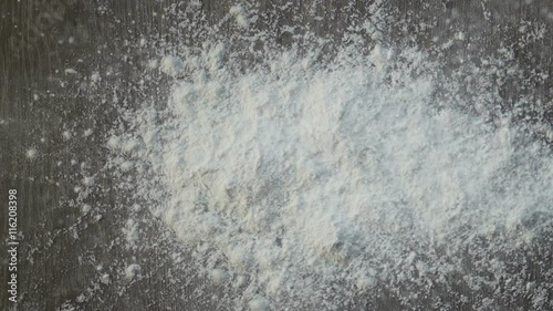 Culinary background texture with scattered dry white cake flour on a kitchen