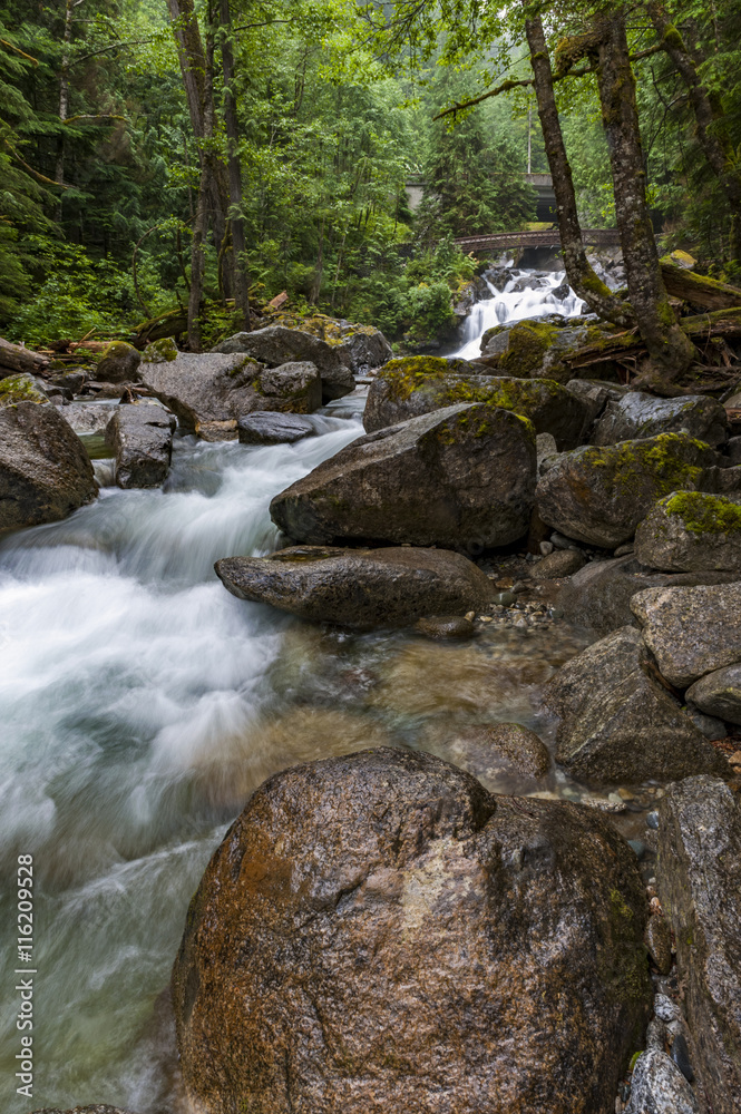 Deception Falls, Skykomish, Washington. Deception Creek crashes down a few steps, then glides over smooth rock under the highway and ends in a square, misty plunge before emptying into the Tye River. Deception Falls, Skykomish, Washington. Deception Creek crashes down a few steps, then glides over smooth rock under the highway and ends in a square, misty plunge before emptying into the Tye River.