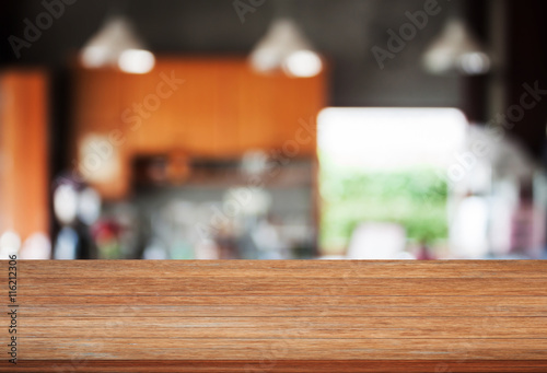 Top wooden with abstract blur coffee shop background