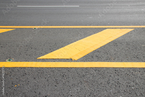 yellow warning sign on asphalt road