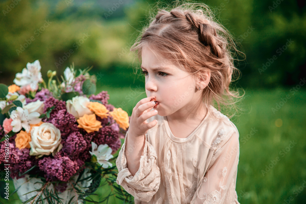 Little baby girl eats chocolate cake in nature at a picnic. The concept of a happy childhood Little baby girl eats chocolate cake in nature at a picnic. The concept of a happy childhood