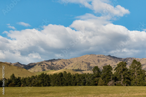 rolling hills in New Zealand with sky and clouds