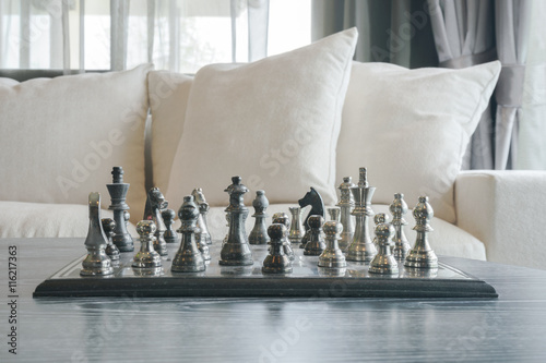 Brass chass on table with white sofa set in living room photo