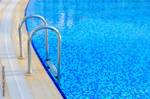 Swimming pool with stair at hotel close-up