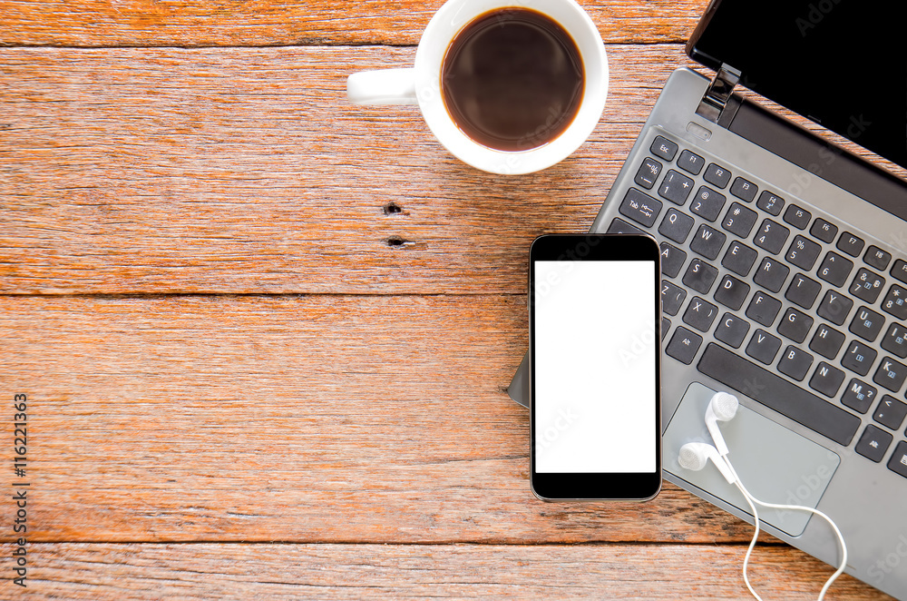 Smart phone,Earphone and Laptop computer with coffee on wooden f Smart phone,Earphone and Laptop computer with coffee on wooden f