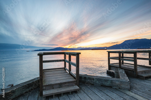 Beautiful sunset viewed from a dock in Jericho Beach, Vancouver, British Columbia, Canada.