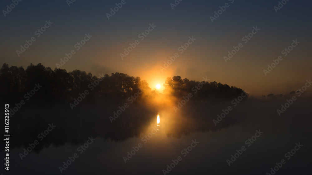 Fototapeta premium Picturesque sunset (sunrise) above land, river and forest. Wide angle