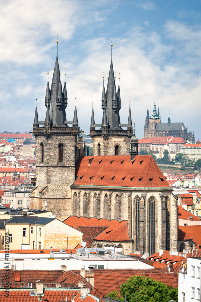 Aerial view of Tyn church in Prague old town and St. Vitus cathedral on background