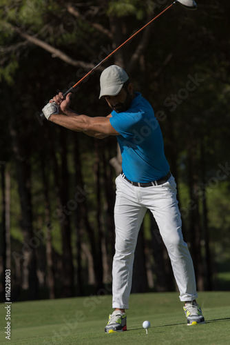 golf player hitting shot
