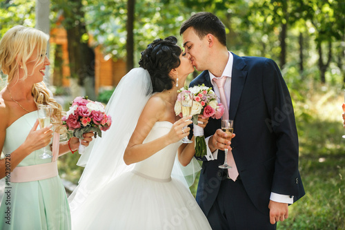 The brides kissing in the park photo