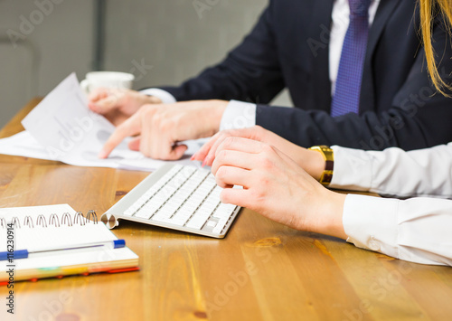 Close-up of woman typing on keyboard in office