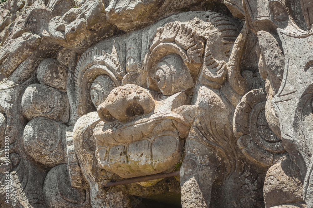 Statue in the entrance of Goa Gajah cave temple , Ubud, Bali, Indonesia.